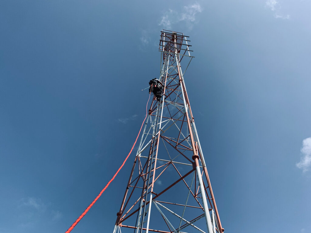 Engineer climbs a tower structure