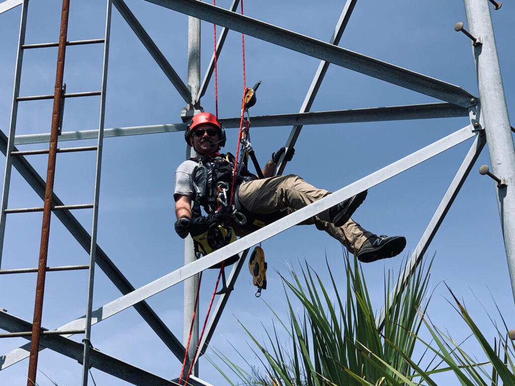 Engineer climbs a tower structure